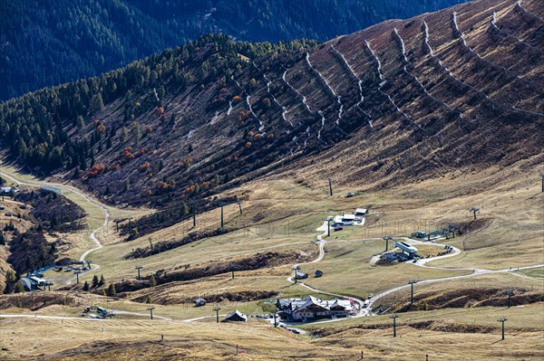 Skiing area in autumn at the Sella Pass, avalanche barrier at the back of the slope, Dolomites, South Tyrol, Italy, Europe