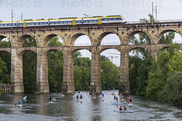 Enz viaduct Bietigheim with regional train, railway viaduct over the river Enz, stand-up paddler, Bietigheim-Bissingen, Baden-Wuerttemberg, Germany, Europe