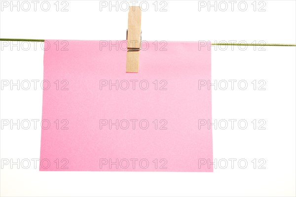 Sticky note hung with a clothespin on a clothesline with copy space and white background