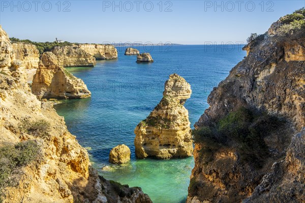 Beautiful cliffs and rock formations by the Atlantic Ocean at Marinha Beach in Algarve, Portugal, Europe