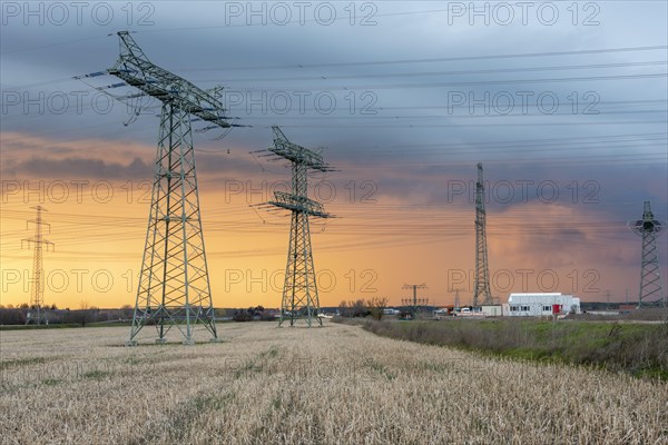 Thunderstorm cell at sunset, high voltage pylons, construction container, Suedostlink construction site, Wolmirstedt, Saxony-Anhalt, Germany, Europe