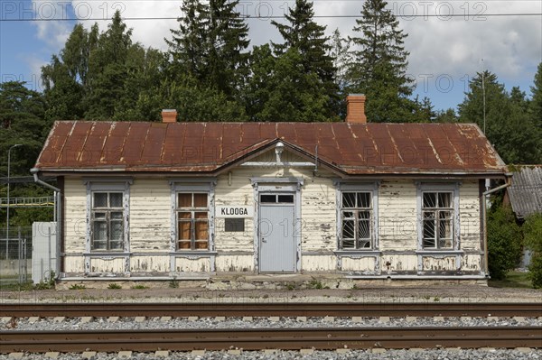 Railway tracks and weathered wooden house at the historic railway station in the village of Klooga, Harju County, Estonia, Europe