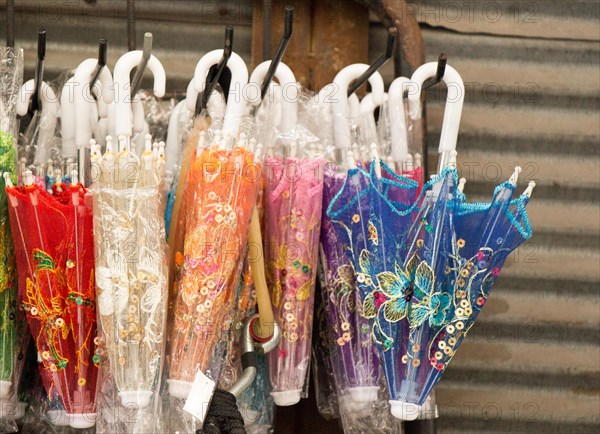 Hanging umbrellas of various color in the market place