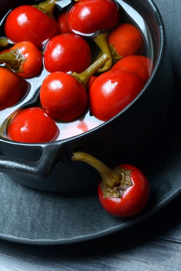 Potted cherry peppers in vinegar, chilli, paprika