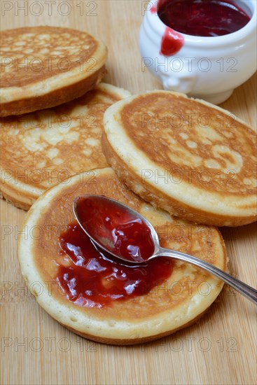 Pancake with raspberry jam and spoon