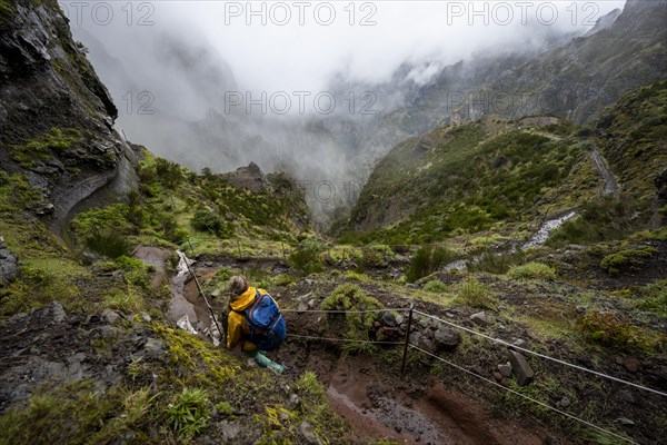 Hiker, Pico Arieiro to Pico Ruivo Hike, Rock Cliff Hiking Trail, Central Mountains of Madeira, Madeira, Portugal, Europe