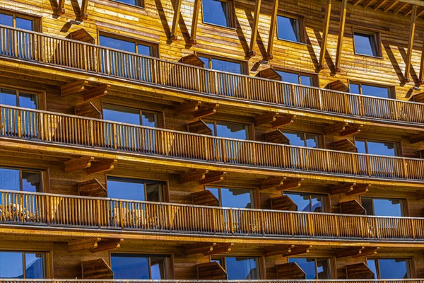 Wooden balconies and wooden facade of the Sporthotel Sonne on the Alpe di Siusi, Val Gardena, Dolomites, South Tyrol, Italy, Europe