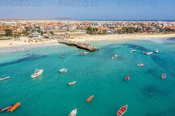 Pier and boats on turquoise water in city of Santa Maria, island of Sal, Cape Verde, Africa
