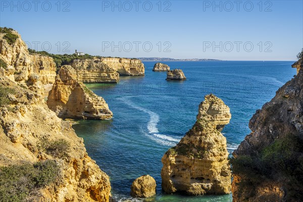 Beautiful cliffs and rock formations by the Atlantic Ocean at Marinha Beach in Algarve, Portugal, Europe