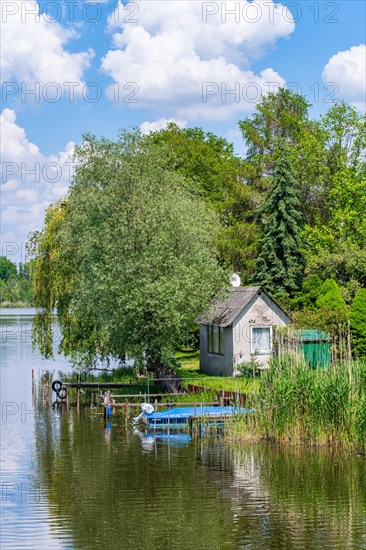 View from the Wublitz Bridge of a garden with a summer house and the Wublitz, a tributary of the Havel, Golm, Potsdam, Brandenburg, Germany, Europe