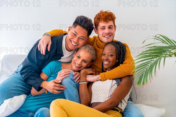 Lgtb couples of gay boys and girls lesbian in a portrait on a sofa at a house party