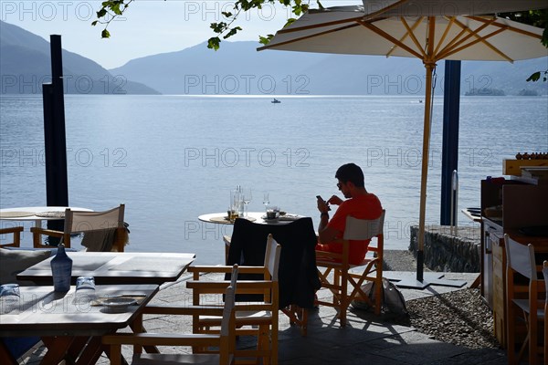 Restaurant on the lake promenade with a view of Lake Maggiore, Ascona, Canton Ticino, Switzerland, Europe