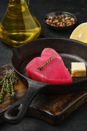 Closeup view of raw fresh tuna steak in cast iron skillet