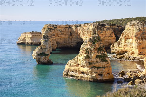 Beautiful cliffs and rock formations by the Atlantic Ocean at Marinha Beach in Algarve, Portugal, Europe