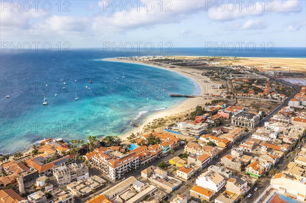 Pier and boats on turquoise water in city of Santa Maria, island of Sal, Cape Verde, Africa