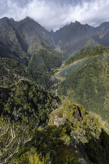 Rainbow in front of mountains, Miradouro dos Balcoes, Ribeira da Metade mountain valley and the central mountains, Madeira, Portugal, Europe