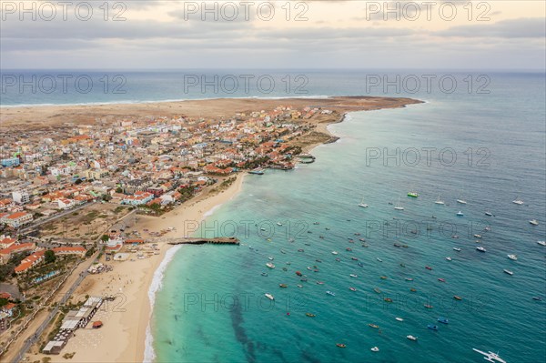 Pier and boats on turquoise water in city of Santa Maria, island of Sal, Cape Verde, Africa