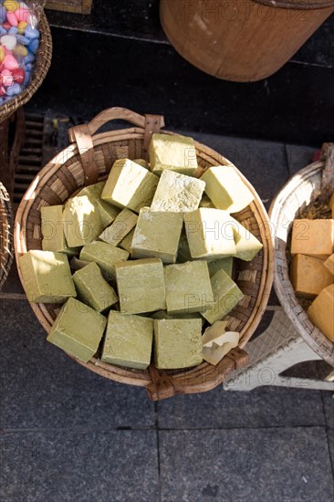 Collection of bars of fragrant hand made organic soap in a basket