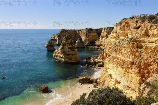 Beautiful cliffs and rock formations by the Atlantic Ocean at Marinha Beach in Algarve, Portugal, Europe