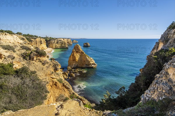 Beautiful cliffs and rock formations by the Atlantic Ocean at Marinha Beach in Algarve, Portugal, Europe