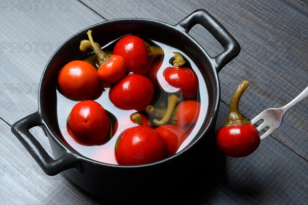 Potted cherry peppers in vinegar, chilli, paprika