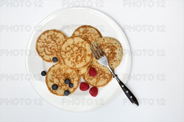 Blini, blinis on plate with fruit, mini pancakes