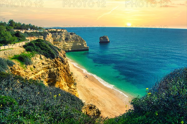 Beautiful cliffs and rock formations by the Atlantic Ocean at Marinha Beach in Algarve, Portugal, Europe