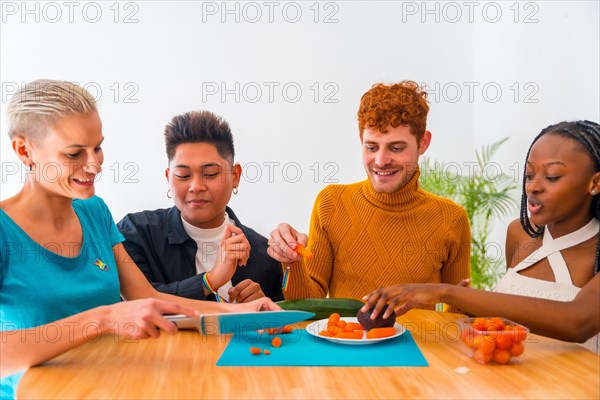 Group of friends preparing vegetarian food. They prepare food and have fun in the kitchen