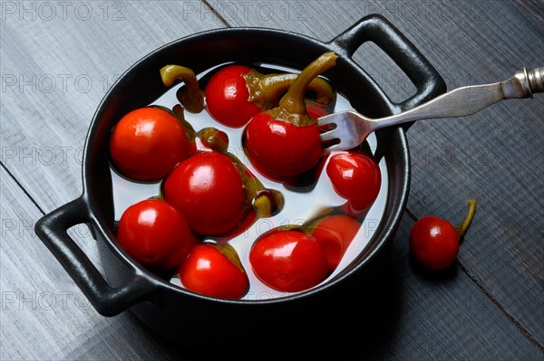 Potted cherry peppers in vinegar, chilli, paprika