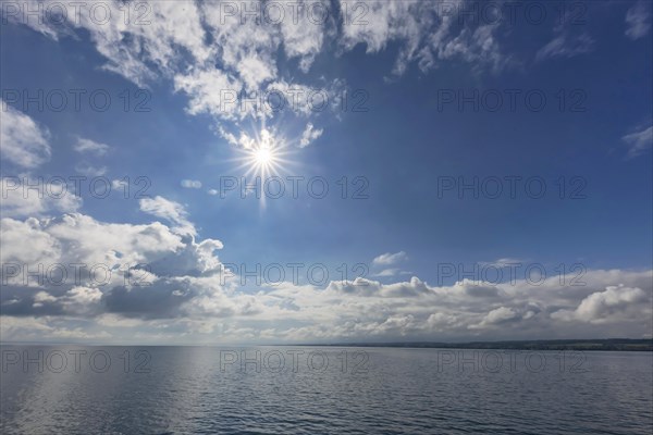 Cloudy atmosphere and sun star over Lake Constance, Constance, Baden-Wuerttemberg, Germany, Europe