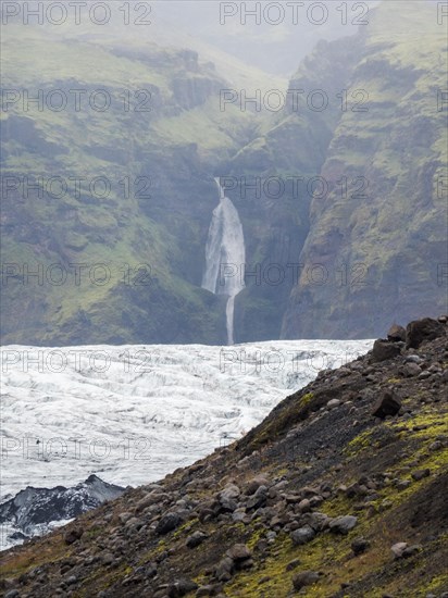 Glacier, Solheimajoekull, Solheimajoekull, glacier tongue of Myrdalsjoekull with inclusion of volcanic ash, waterfall behind, near Ring Road, Suourland, South Iceland, Iceland, Europe