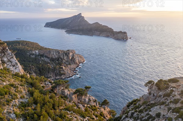 Rocky coast with an island, Sunset over the ocean, Mirador Jose Sastre, Sa Dragenora Island, Mallorca, Spain, Europe