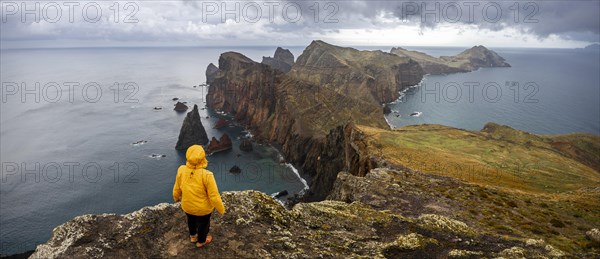 Hiker, coastal landscape, cliffs and sea, Miradouro da Ponta do Rosto, rugged coastline with rock formations, Cape Ponta de Sao Lourenco, Madeira, Portugal, Europe