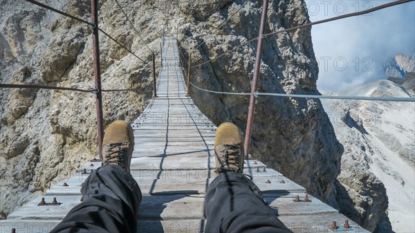 Tourist on the suspension bridge in Monte Cristallo, Dolomite Alps, Italy, Dolomites, Italy, Europe