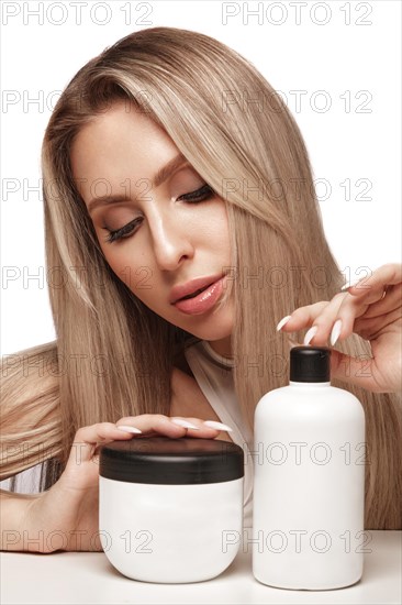 Beautiful blond girl with a perfectly hair, and classic make-up with cosmetic products. Beauty face and hair. Picture taken in the studio
