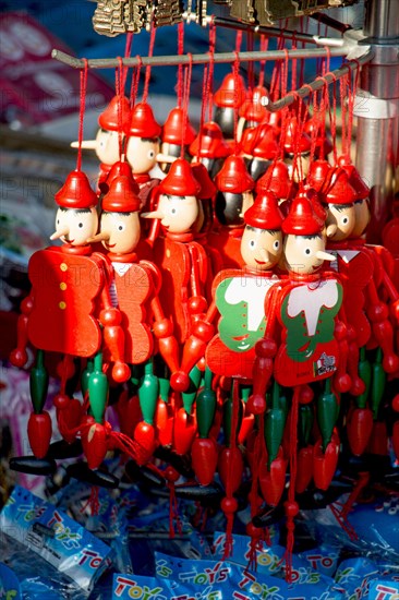 Set of wooden pinocchio dolls with his long nose on a white background