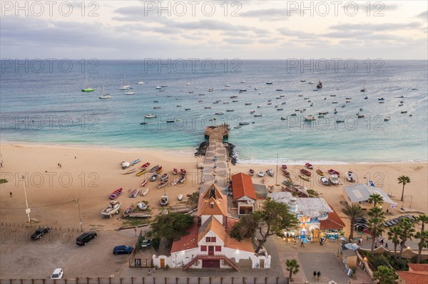 Pier and boats on turquoise water in city of Santa Maria, island of Sal, Cape Verde, Africa