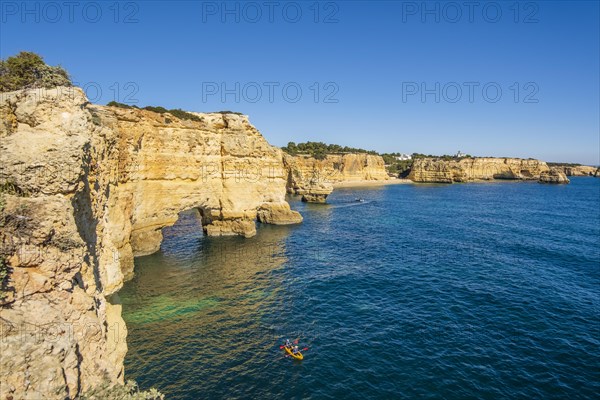 Beautiful cliffs and rock formations by the Atlantic Ocean at Marinha Beach in Algarve, Portugal, Europe