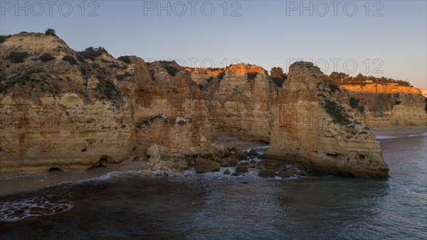 Sunset at Praia da Marinha, rocks and cliffs, steep coast in the Algarve, Portugal, Europe