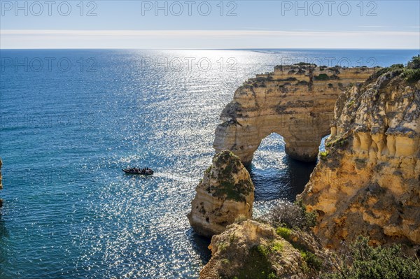 Beautiful cliffs and rock formations by the Atlantic Ocean at Marinha Beach in Algarve, Portugal, Europe