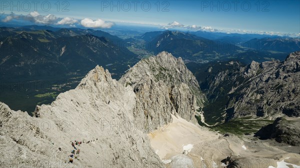 View of the mountain range and tourists entering the via ferrata trail. Zugspitze massif in the bavarian alps, Dolomites, Italy, Europe