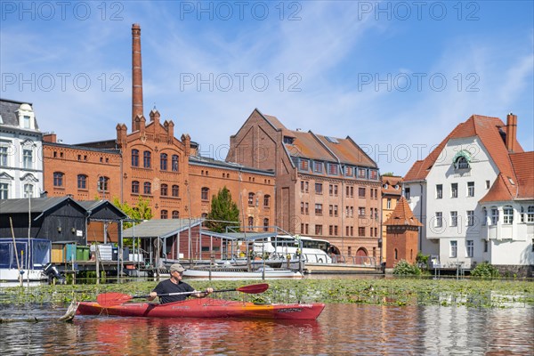 Paddlers in a kayak on the Havel, industrial architecture behind, Brandenburg an der Havel, Brandenburg, Germany, Europe