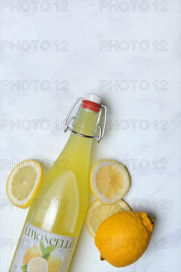 Limoncello, lemon liqueur in bottle and lemons