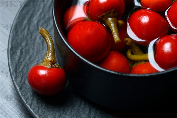 Potted cherry peppers in vinegar, chilli, paprika