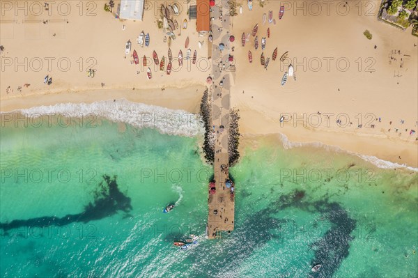 Pier and boats on turquoise water in city of Santa Maria, island of Sal, Cape Verde, Africa