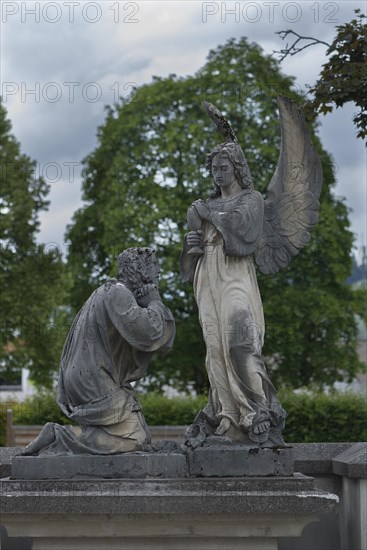 Sculptures on an old tomb, cemetery of Riezlern in Kleinwalsertal, Austria, Europe