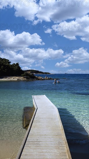 Bathing jetty from the beach into the water, opposite the island of Ishujt e Ksamilit, Ksamil, Albania, Europe