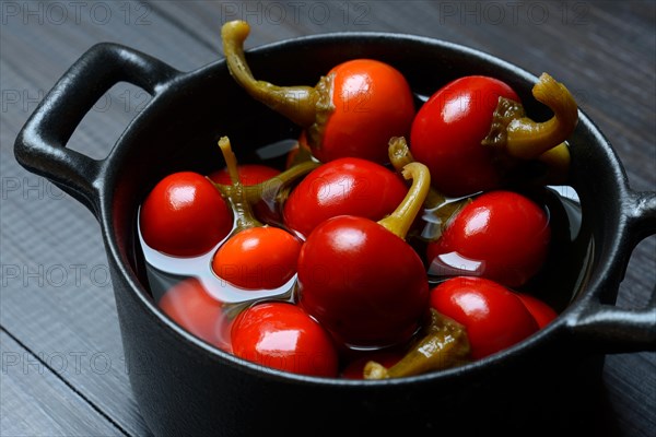 Potted cherry peppers in vinegar, chilli, paprika