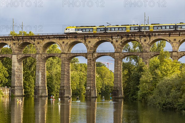 Enz viaduct Bietigheim with regional train, railway viaduct over the river Enz, stand-up paddler, Bietigheim-Bissingen, Baden-Wuerttemberg, Germany, Europe