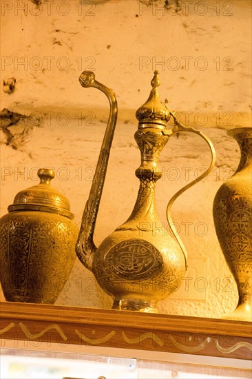 Ancient metal jug in oriental style in antique market